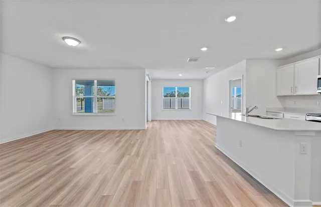 a view of kitchen and sink with wooden floor