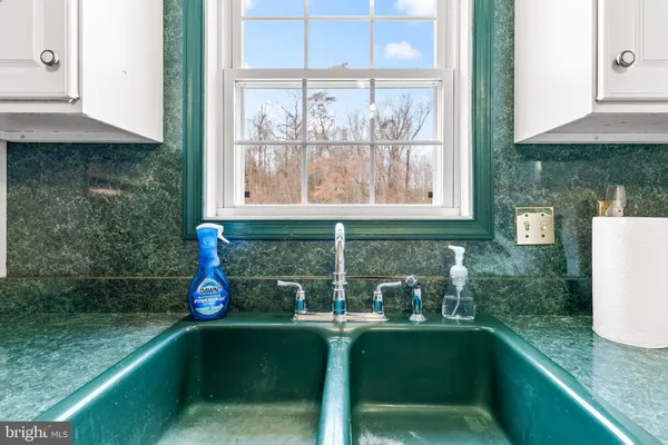 a kitchen with stainless steel appliances granite countertop a sink and a window