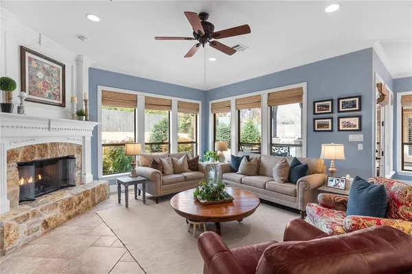 a view of a hallway to a kitchen with wooden floor and electronic appliances
