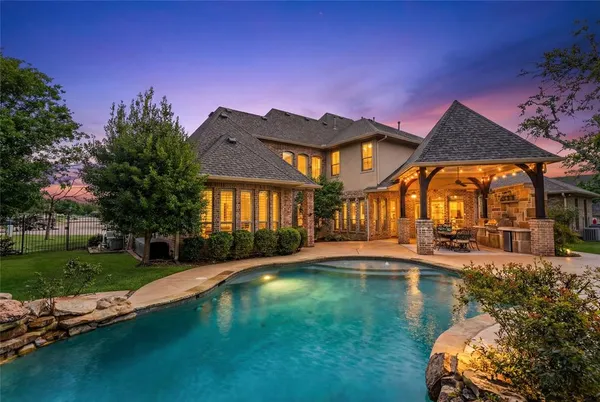 a view of a house with swimming pool and a yard