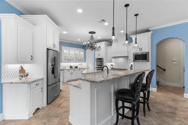 a large kitchen with a table and chairs