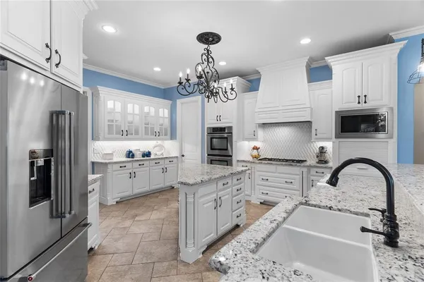 a view of a dining room with furniture wooden floor and chandelier