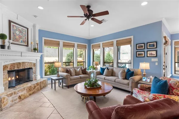 a view of a hallway to a kitchen with wooden floor and electronic appliances