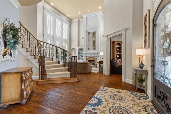 a view of entryway and hall with wooden floor
