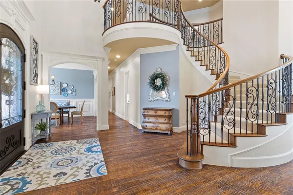a view of entryway livingroom and hall with wooden floor