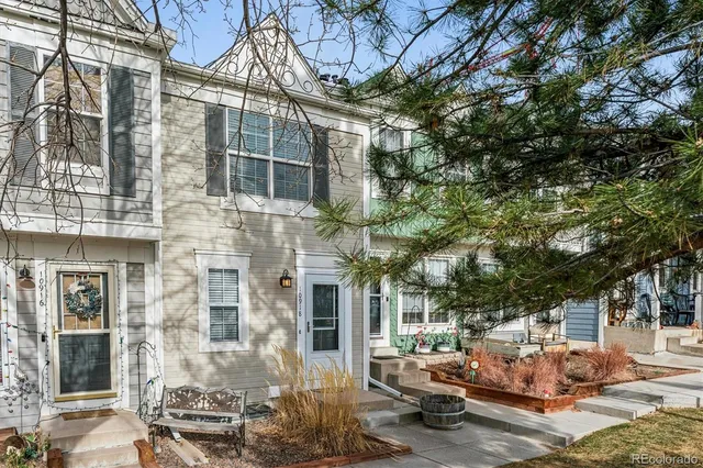 a couple of cars parked in front of a building