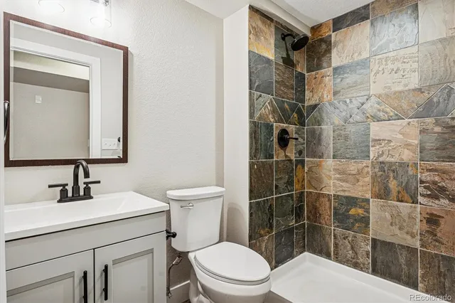 a bathroom with a toilet sink and shower