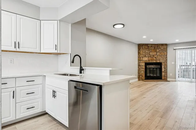 a kitchen with a sink cabinets and appliances