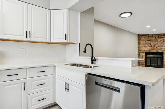 a kitchen with cabinets appliances a sink and a counter space