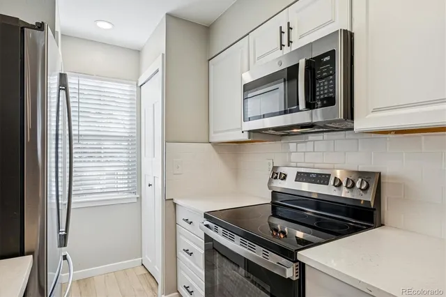 a kitchen with appliances and cabinets