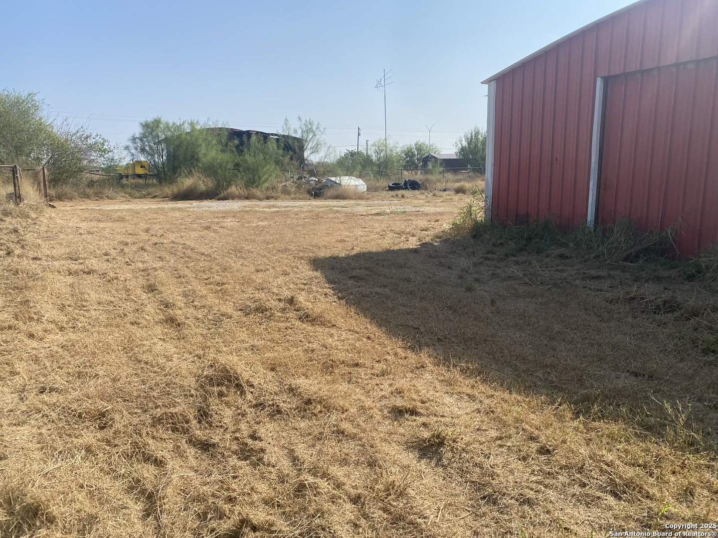 15650 Interstate 35 Dilley, TX 78017 - Photo 5 of 7 a view of a dry yard with wooden fence