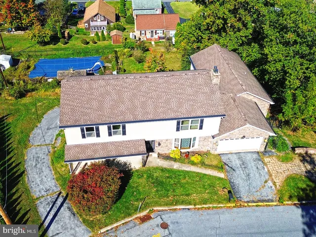 an aerial view of a house with a yard basket ball court and outdoor seating