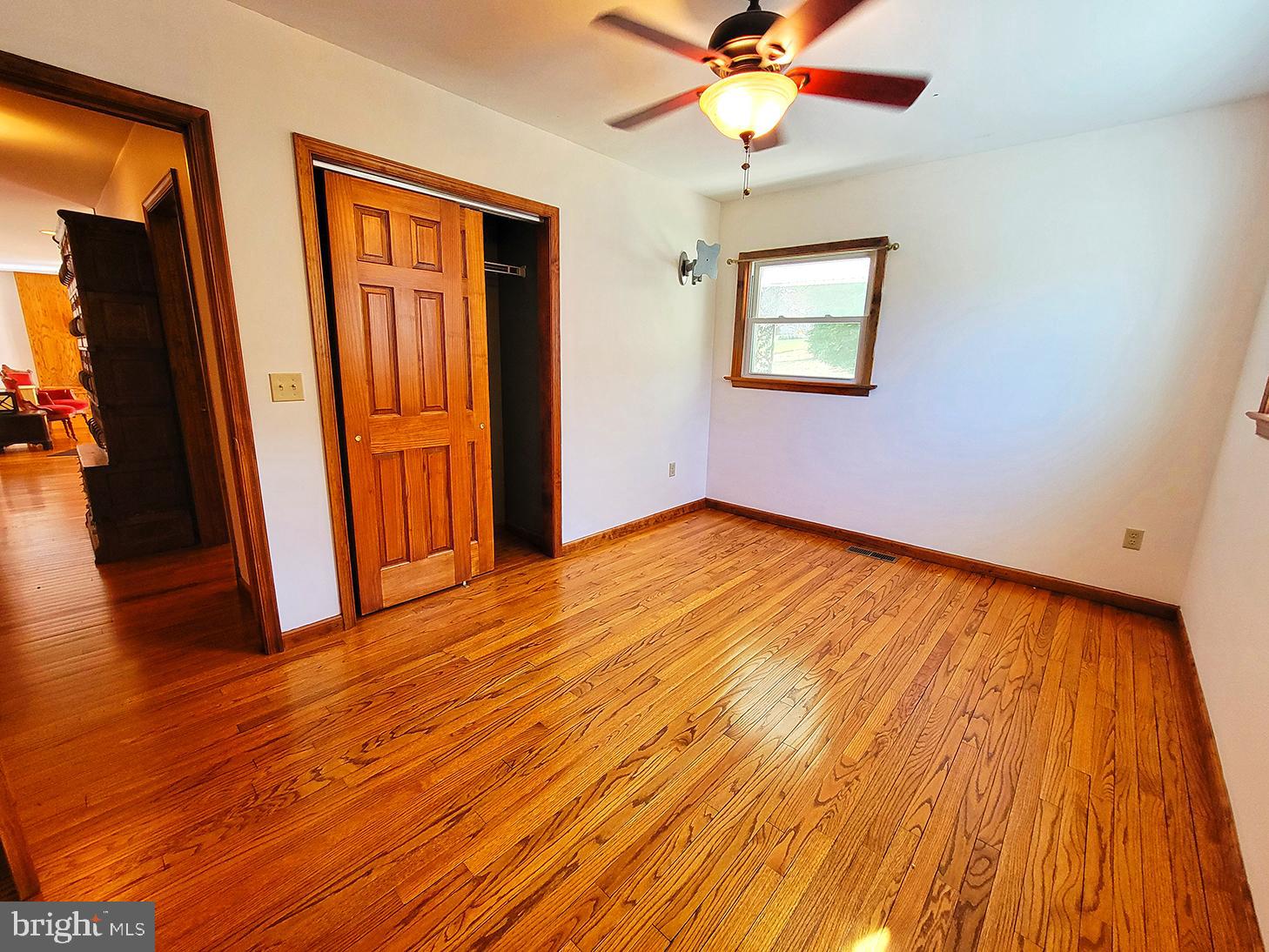 1018 Crestview Avenue Shillington, PA 19607 - Photo 13 of 47 a view of an empty room with wooden floor and a ceiling fan