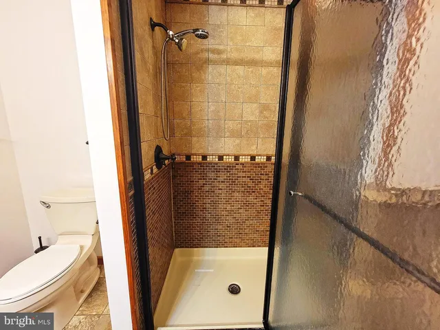 a kitchen with granite countertop a stove top oven microwave and cabinets