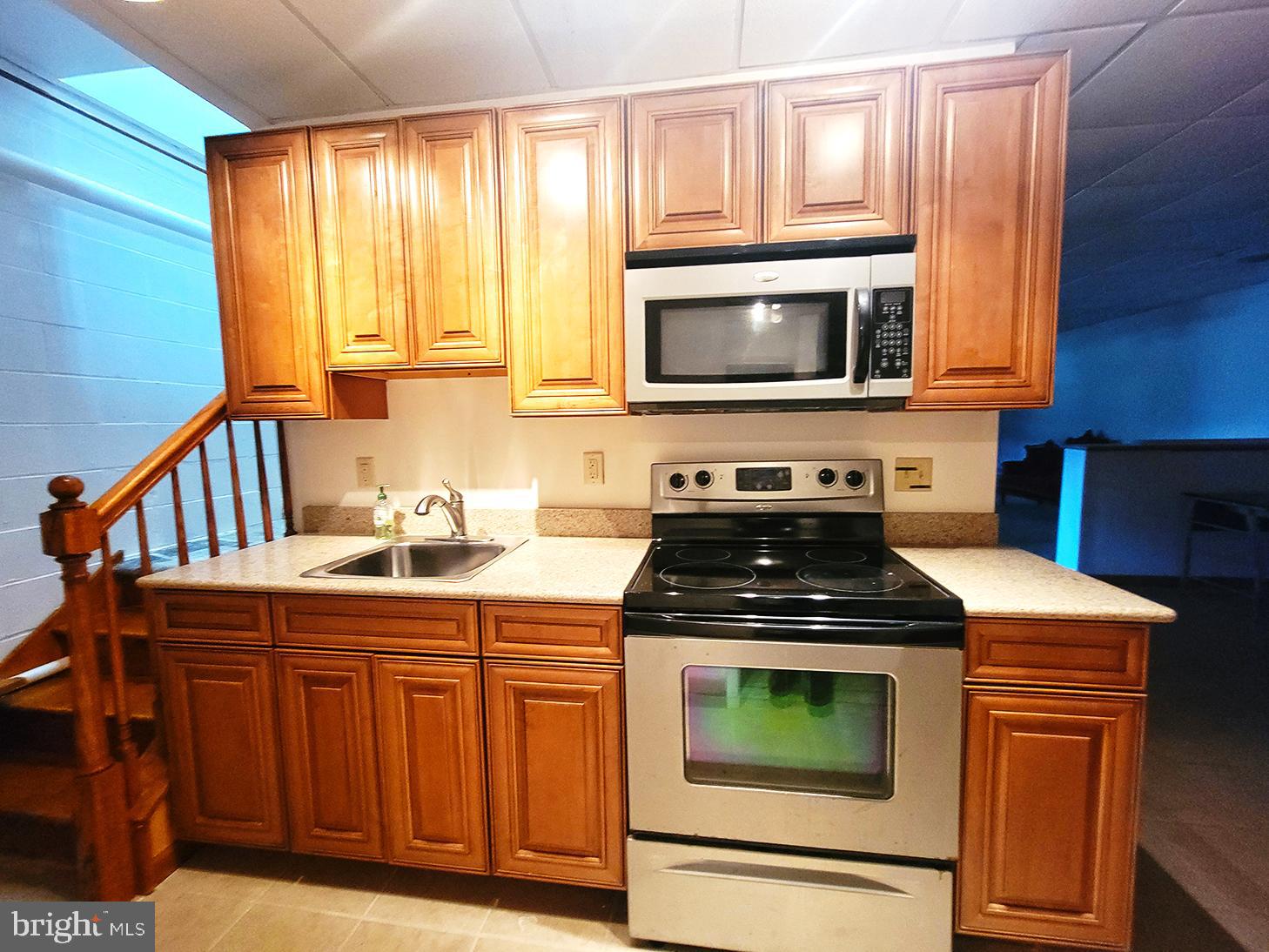 1018 Crestview Avenue Shillington, PA 19607 - Photo 27 of 47 a kitchen with granite countertop a stove top oven microwave and cabinets