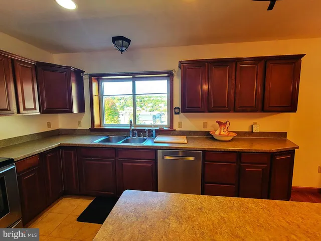 a kitchen with a sink cabinets and window
