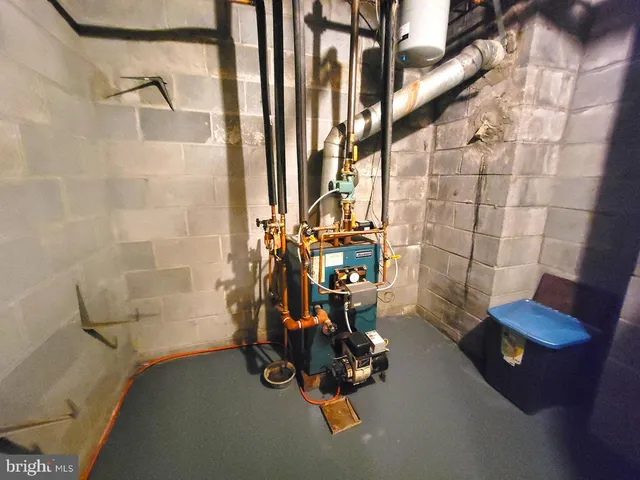 a room with stainless steel appliances wooden floor and chair