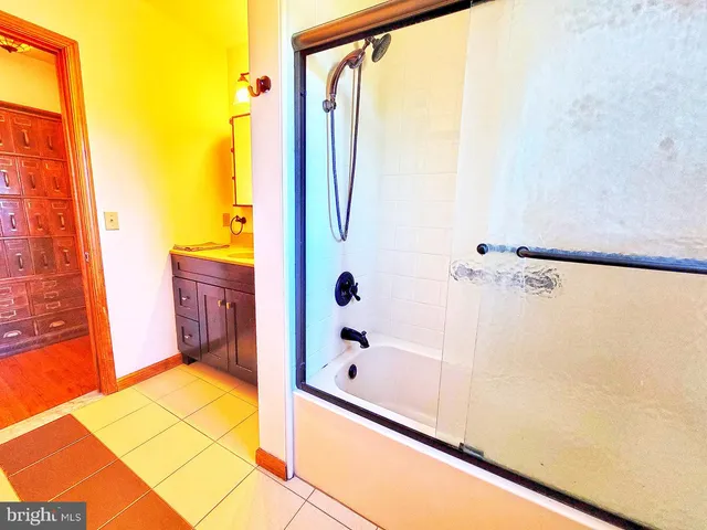 a bathroom with a tub and shower