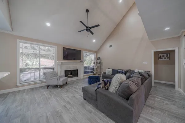 a living room with furniture a fireplace and a flat screen tv