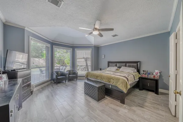 a spacious bedroom with a bed and a large window