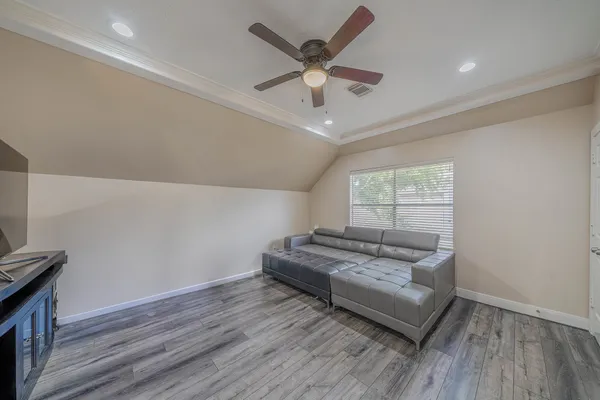 a living room with furniture and a wooden floor