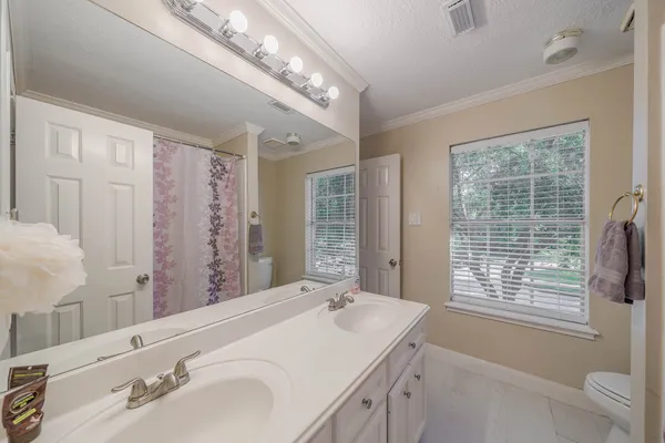 a bathroom with a double vanity sink and a large mirror