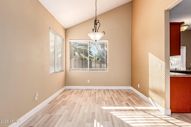 a view of a room with wooden floor and windows