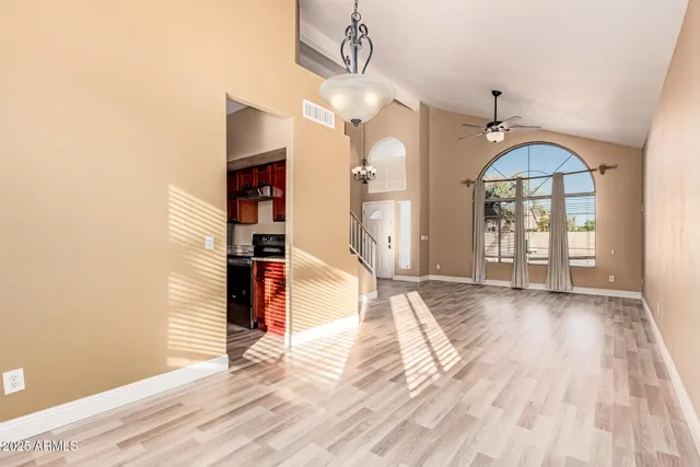 a view of a livingroom with wooden floor and a large window