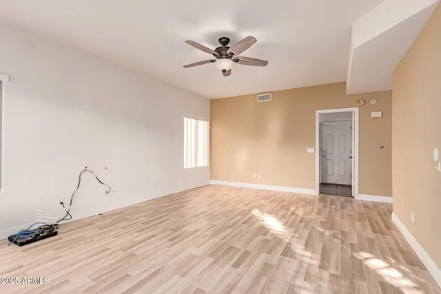 a view of a livingroom with a ceiling fan and window
