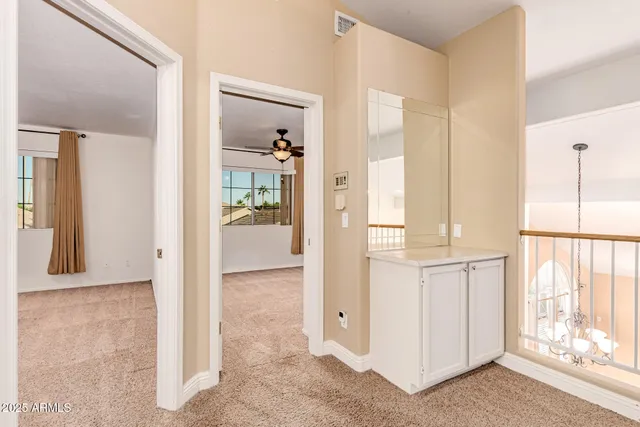 hallway with wooden floor and windows