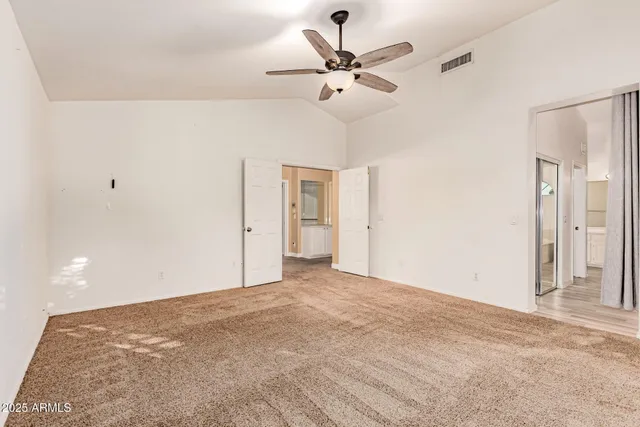 a view of a big room with wooden floor and a ceiling fan