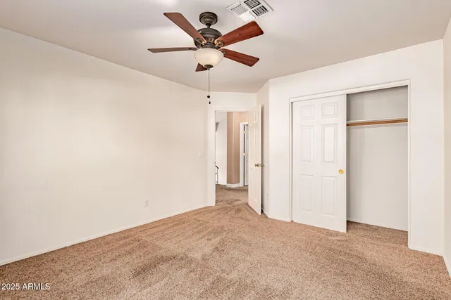 an empty room with a ceiling fan and a ceiling fan