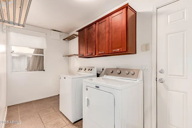 a view of storage and utility room with washer and dryer