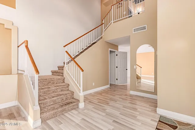 a view of entryway and hall with wooden floor