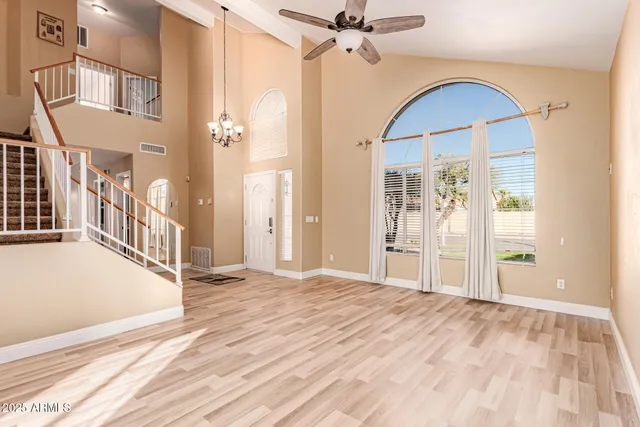 a view of an empty room with cabinet and a window