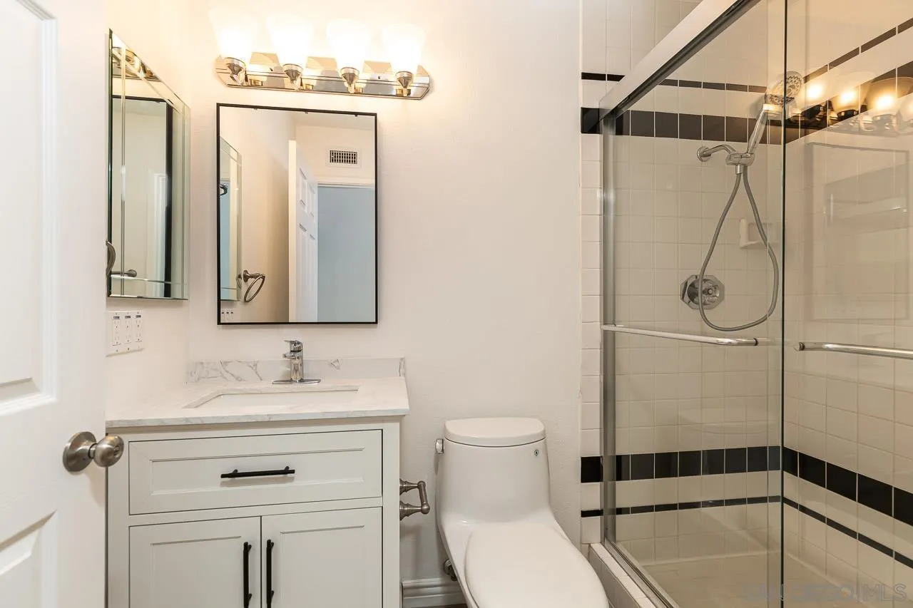 8065 Caminito Gianna La Jolla, CA 92037 - Photo 16 of 27 a bathroom with a sink a toilet and shower