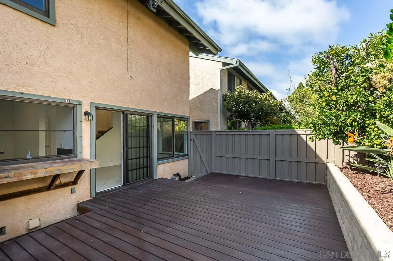 8065 Caminito Gianna La Jolla, CA 92037 - Photo 24 of 27 a view of a house with a wooden deck