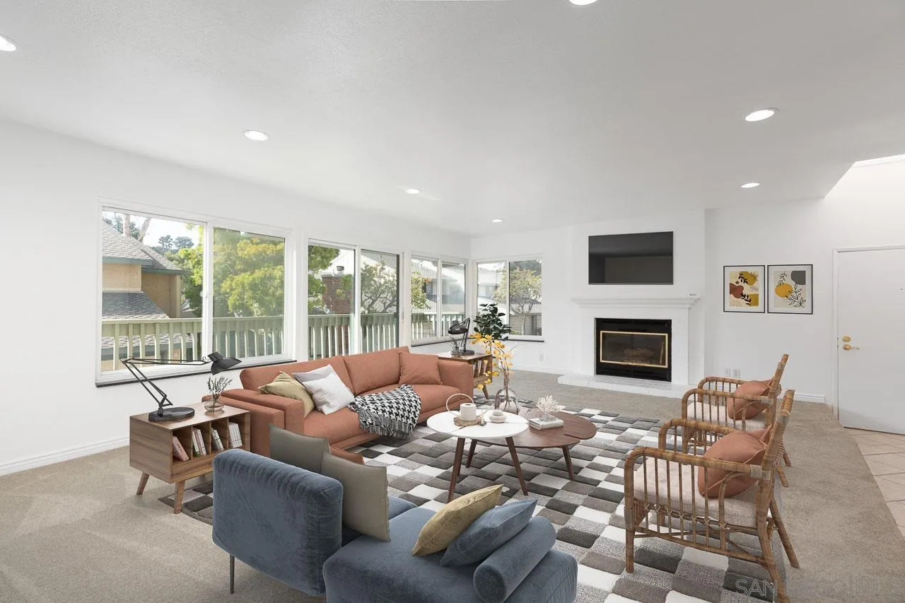 8065 Caminito Gianna La Jolla, CA 92037 - Photo 4 of 27 a living room with furniture a fireplace and a floor to ceiling window