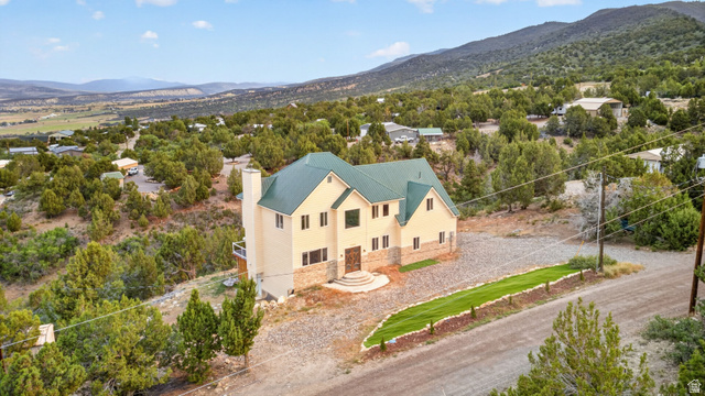 12645 East Cedar Ridge Drive Fairview, UT 84629 - Photo 32 of 34 Multi-story residence featuring a green metal roof and a light-colored exterior with stone accents