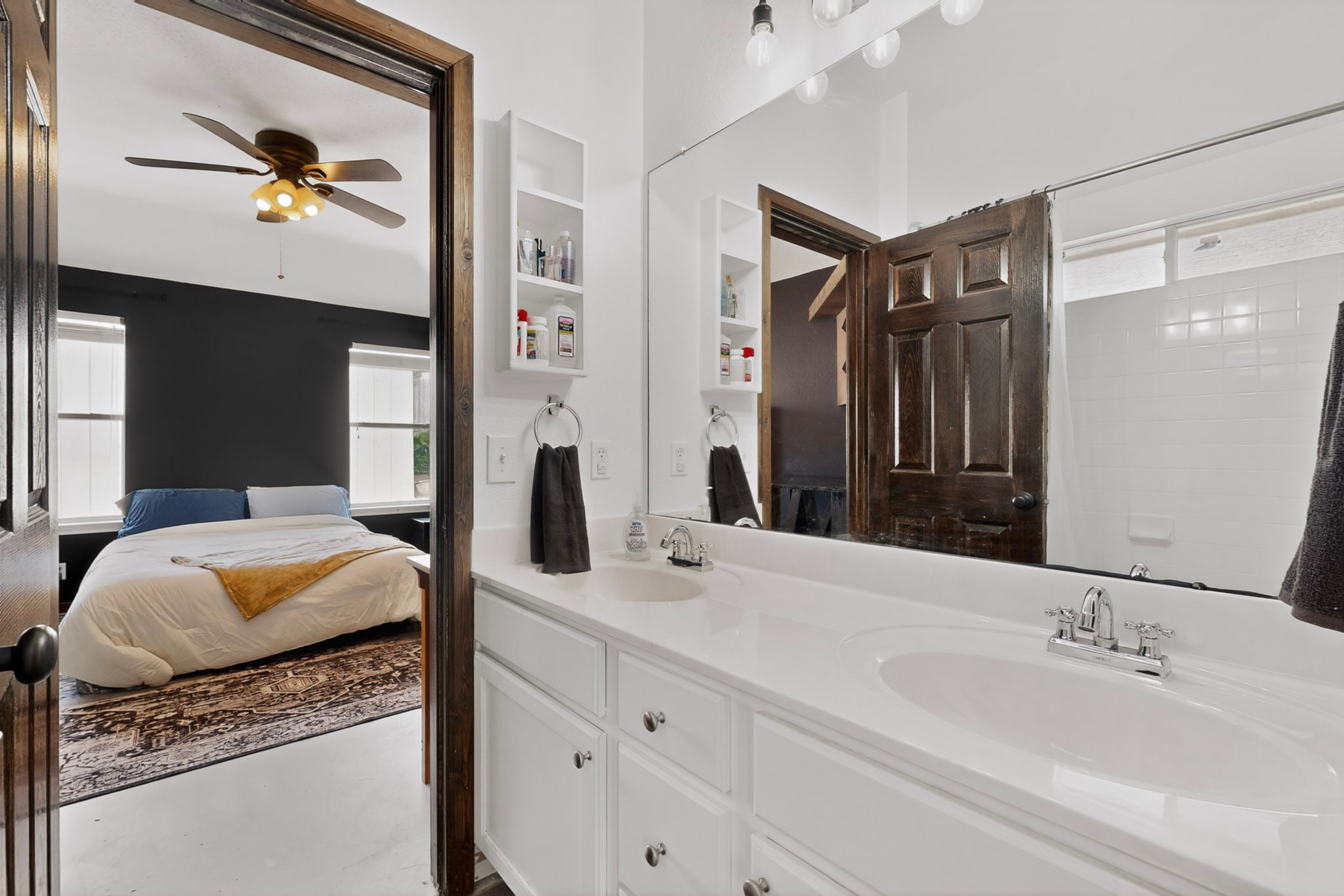 15104 Mimebark Way Austin, TX 78724 - Photo 22 of 38 Bathroom featuring a dual-sink vanity with white cabinetry and chrome fixtures, illuminated by overhead vanity lighting