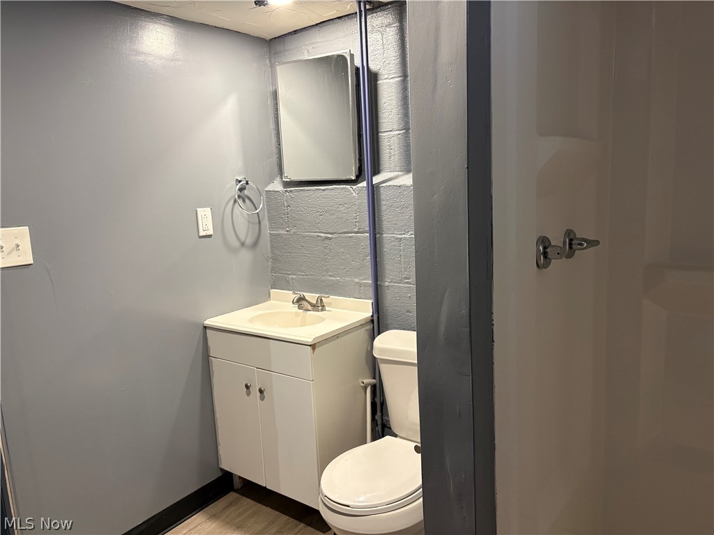 15521 Corkhill Road Maple Heights, OH 44137 - Photo 18 of 33 Half bath with vanity and light wood finished floors