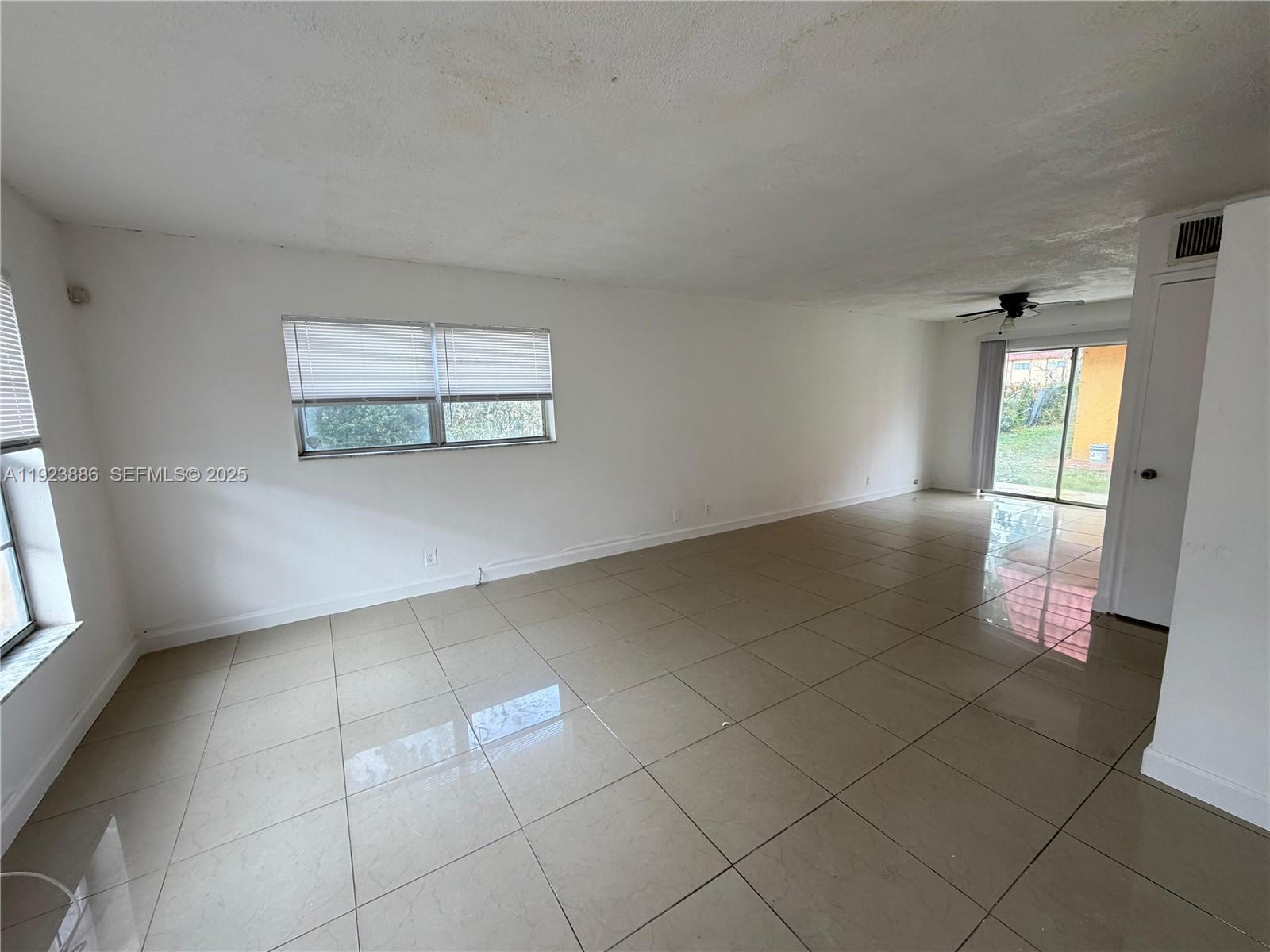 5327 Northwest 27th Street, Unit D4 Lauderhill, FL 33313 - Photo 4 of 14 wooden floor in an empty room with a window