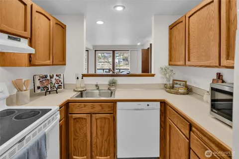 a kitchen with a sink refrigerator and cabinets