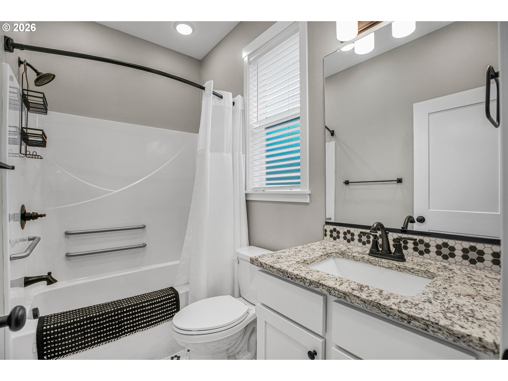 2308 Southeast Risley Avenue Milwaukie, OR 97267 - Photo 17 of 28 a bathroom with a granite countertop sink a mirror and a toilet