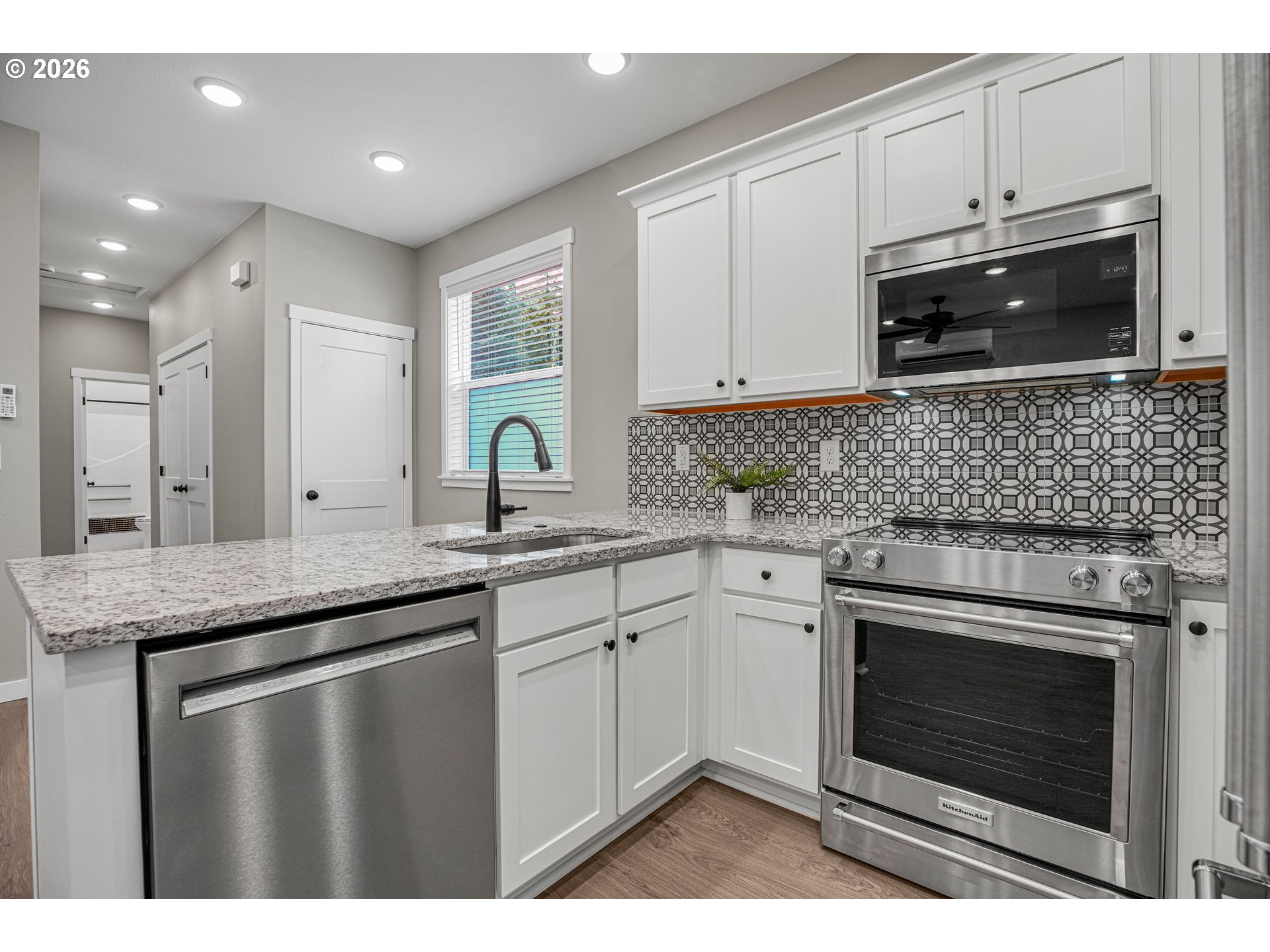 2308 Southeast Risley Avenue Milwaukie, OR 97267 - Photo 8 of 28 a kitchen with granite countertop a stove sink and cabinets