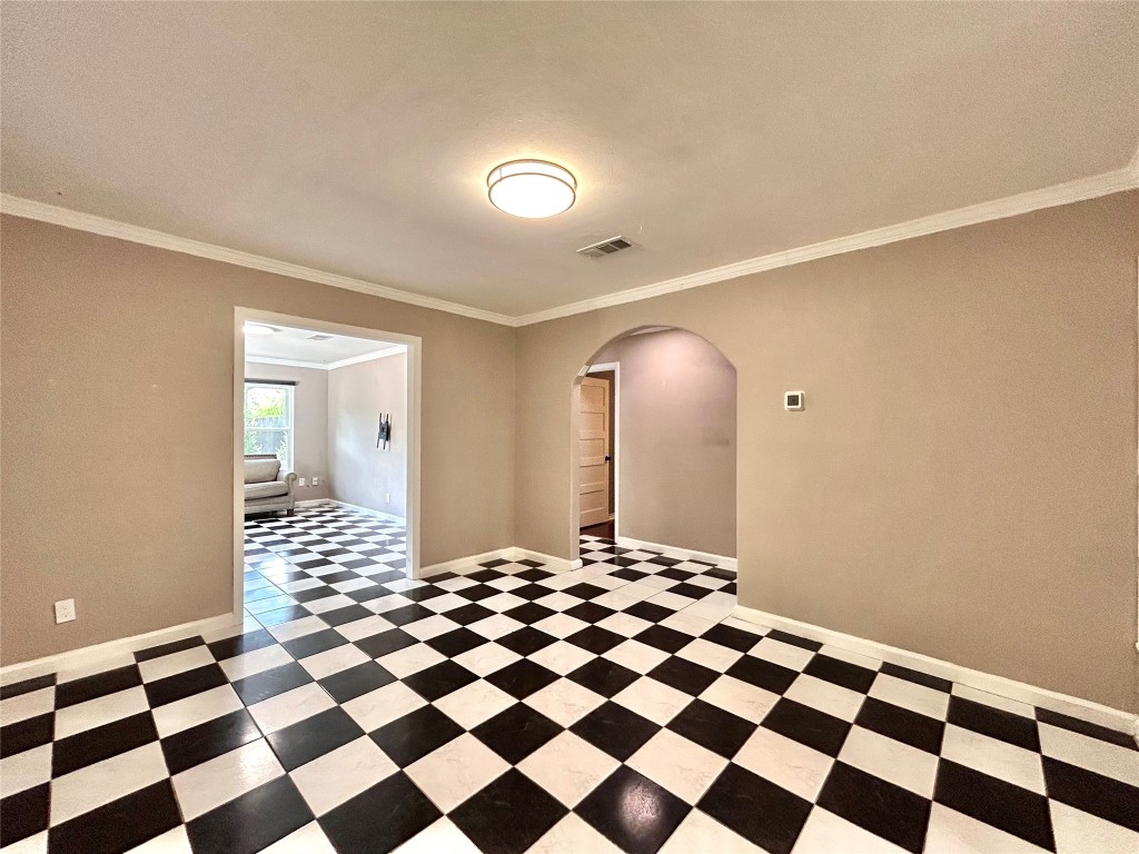 2309 Devonshire Drive, Unit A Austin, TX 78723 - Photo 15 of 39 Unfurnished room featuring arched walkways and ornamental molding