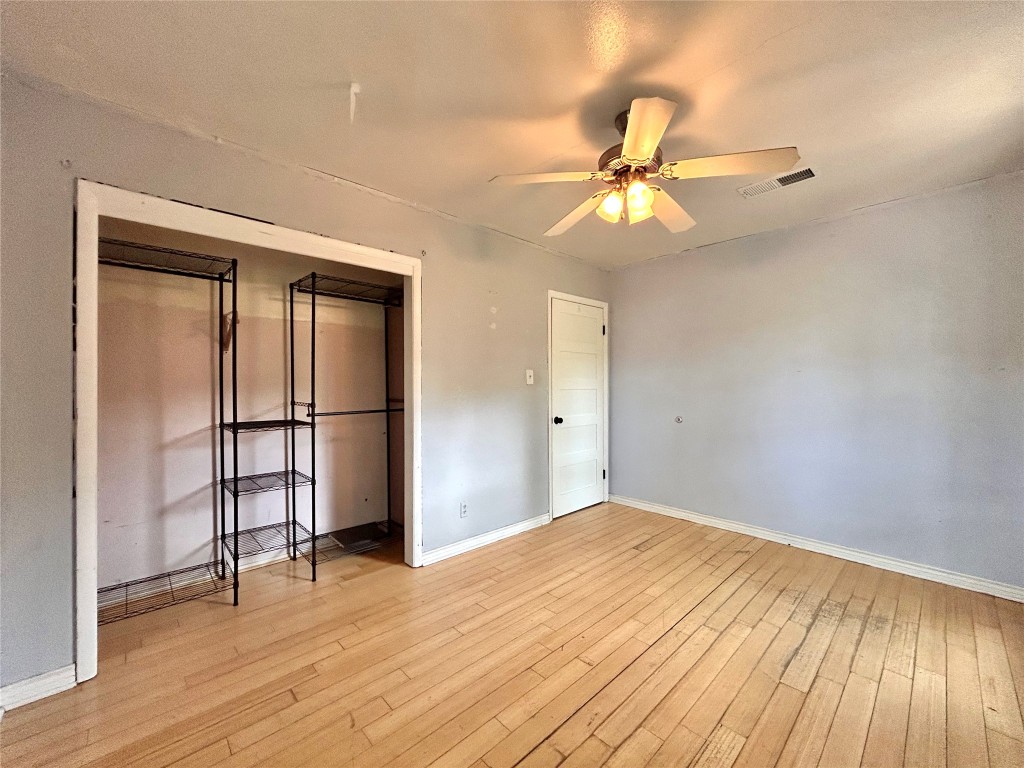 2309 Devonshire Drive, Unit A Austin, TX 78723 - Photo 18 of 39 Unfurnished bedroom with a closet, light wood-type flooring, and a ceiling fan