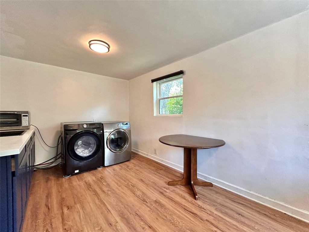 2309 Devonshire Drive, Unit A Austin, TX 78723 - Photo 37 of 39 Laundry area with washing machine and dryer and light wood finished floors