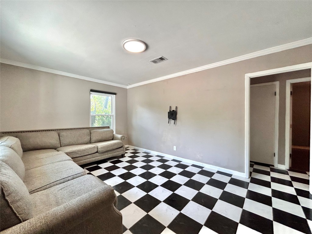 2309 Devonshire Drive, Unit A Austin, TX 78723 - Photo 10 of 39 Living room with crown molding and tile patterned floors