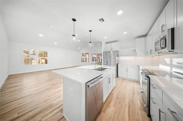 a kitchen with a stove a sink and a refrigerator